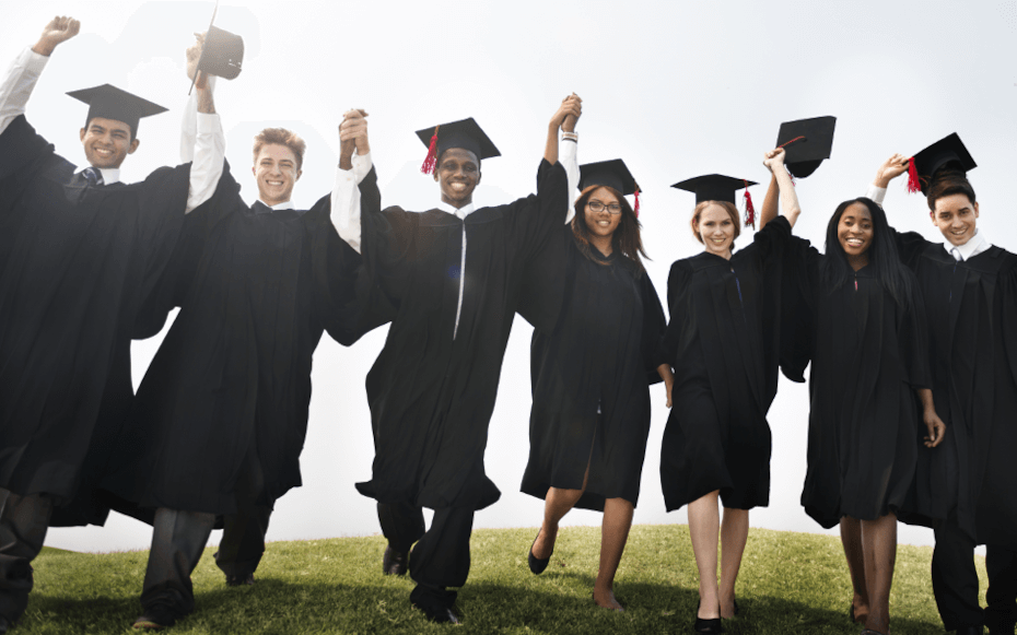 Seven students in graduation attire